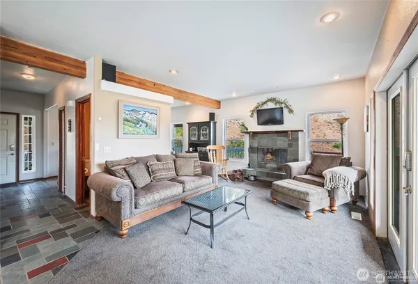 a living room with furniture and large windows