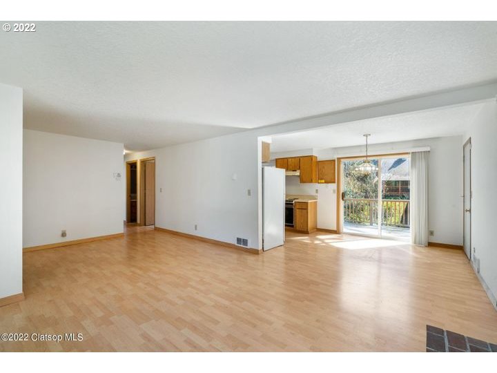 9175 Nehalem Road Nehalem, OR 97131 - Photo 3 of 25 a view of an empty room with a window and wooden floor