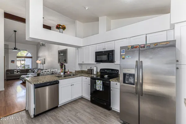 a kitchen with stainless steel appliances a refrigerator stove and microwave