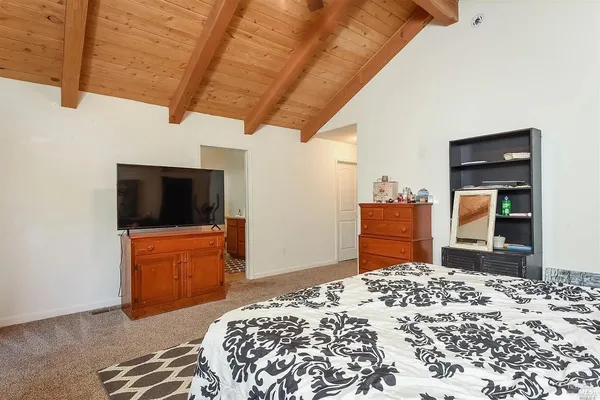 a bedroom with a bed and a television in it