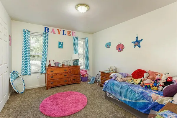 a bedroom with a bed and a couch