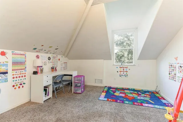 a bedroom with furniture and a baby crib