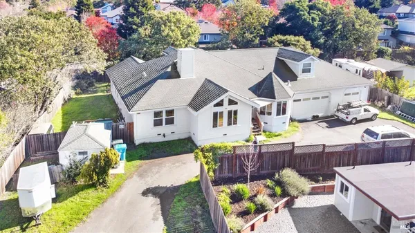 a view of a house with wooden fence