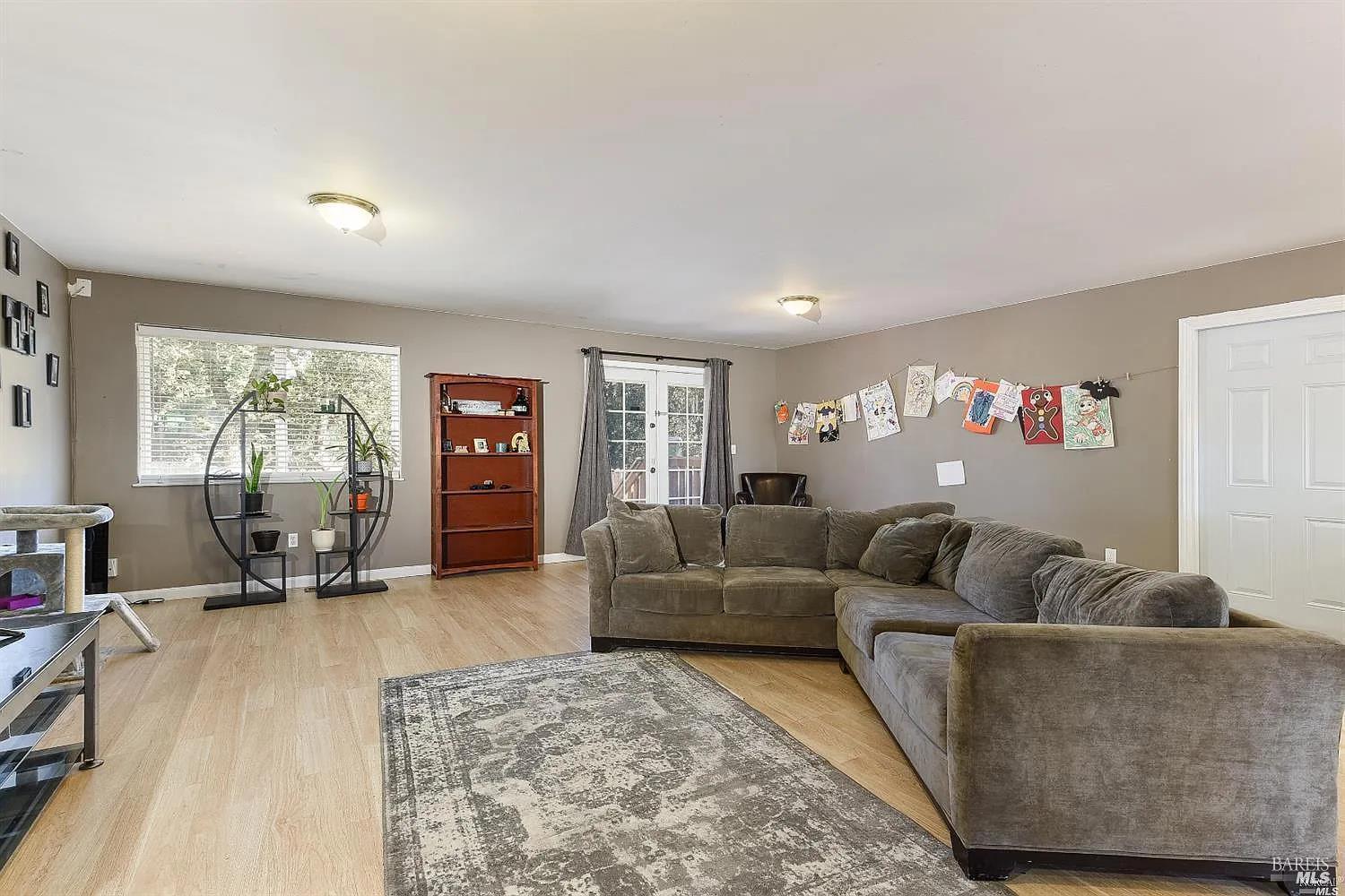 1648 Ronne Drive Santa Rosa, CA 95404 - Photo 6 of 26 a living room with furniture and a flat screen tv