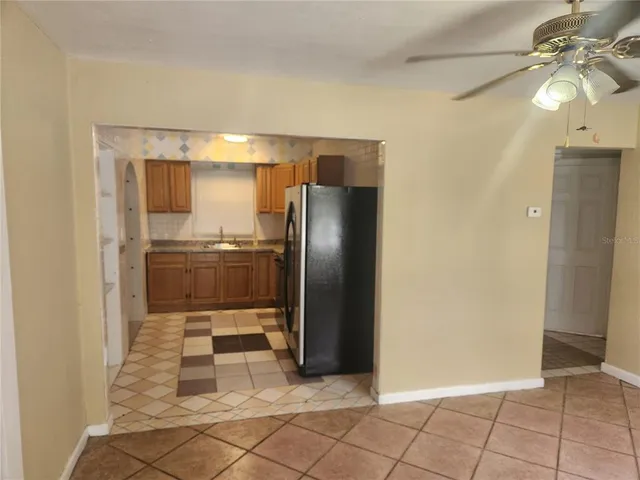 a kitchen with granite countertop a refrigerator and a sink