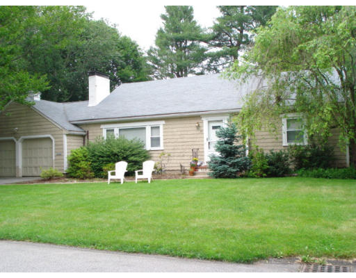 48 Chesterton Road Wellesley, MA 02481 - Photo 1 of 1 a front view of a house with a yard and trees