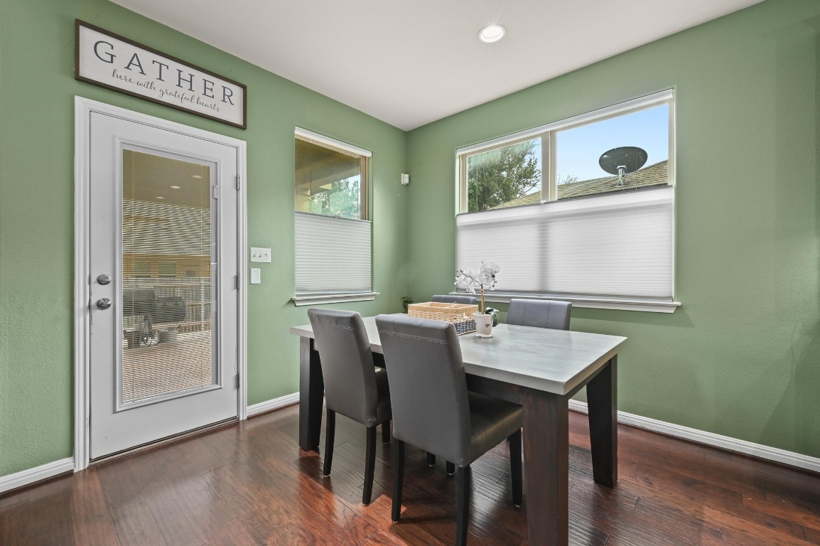 154 Pettigrew Path Buda, TX 78610 - Photo 11 of 36 a view of a dining room with furniture and wooden floor