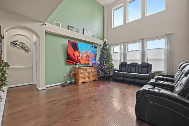 a living room with furniture a flat screen tv and a fireplace