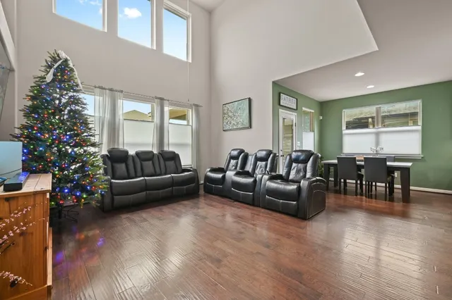 a living room with furniture and a christmas tree