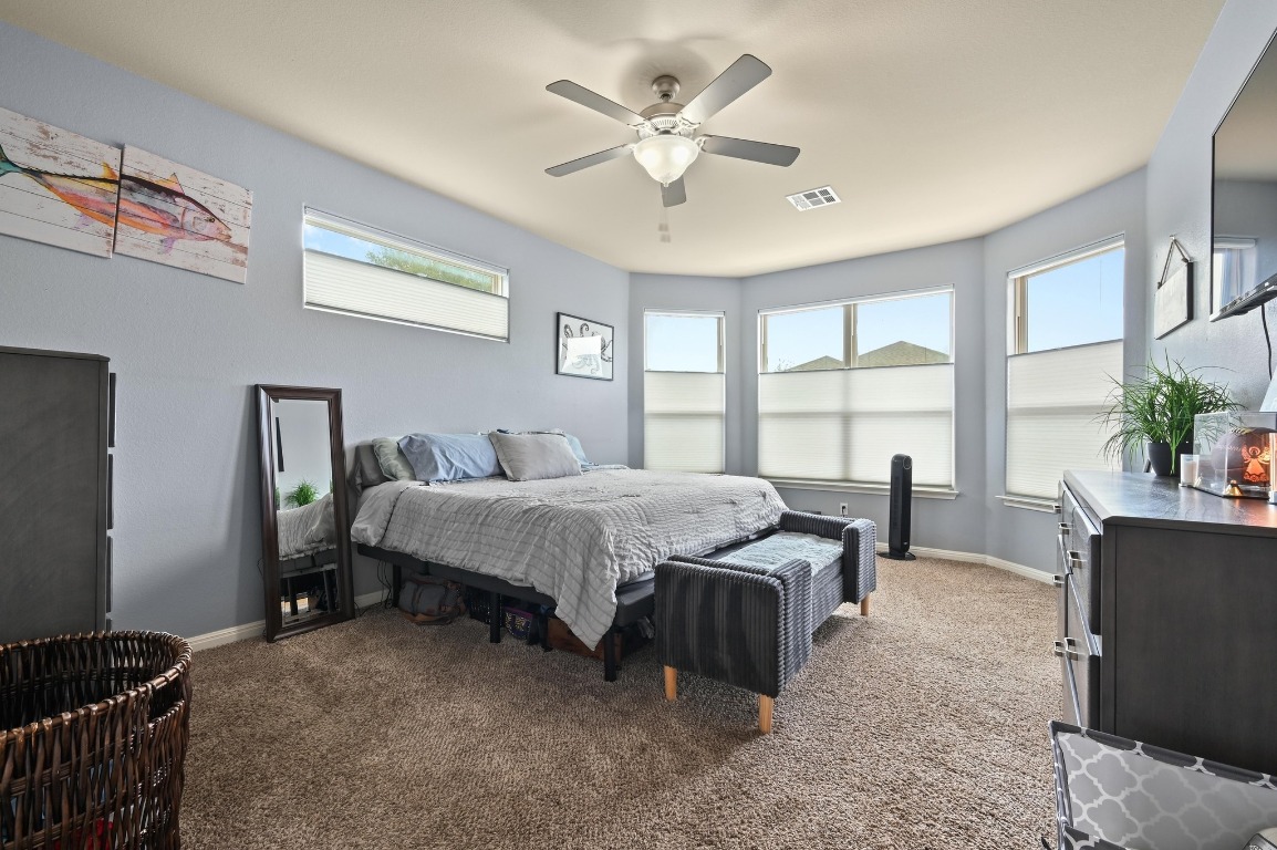 154 Pettigrew Path Buda, TX 78610 - Photo 16 of 36 a bedroom with a bed and window