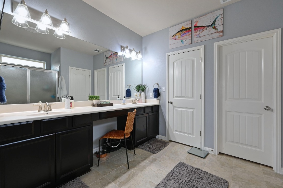 154 Pettigrew Path Buda, TX 78610 - Photo 18 of 36 a bathroom with a sink vanity and a mirror