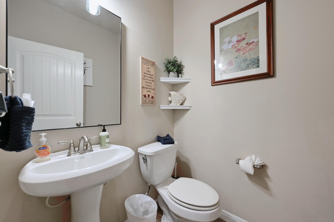 154 Pettigrew Path Buda, TX 78610 - Photo 20 of 36 a bathroom with a toilet a sink and mirror