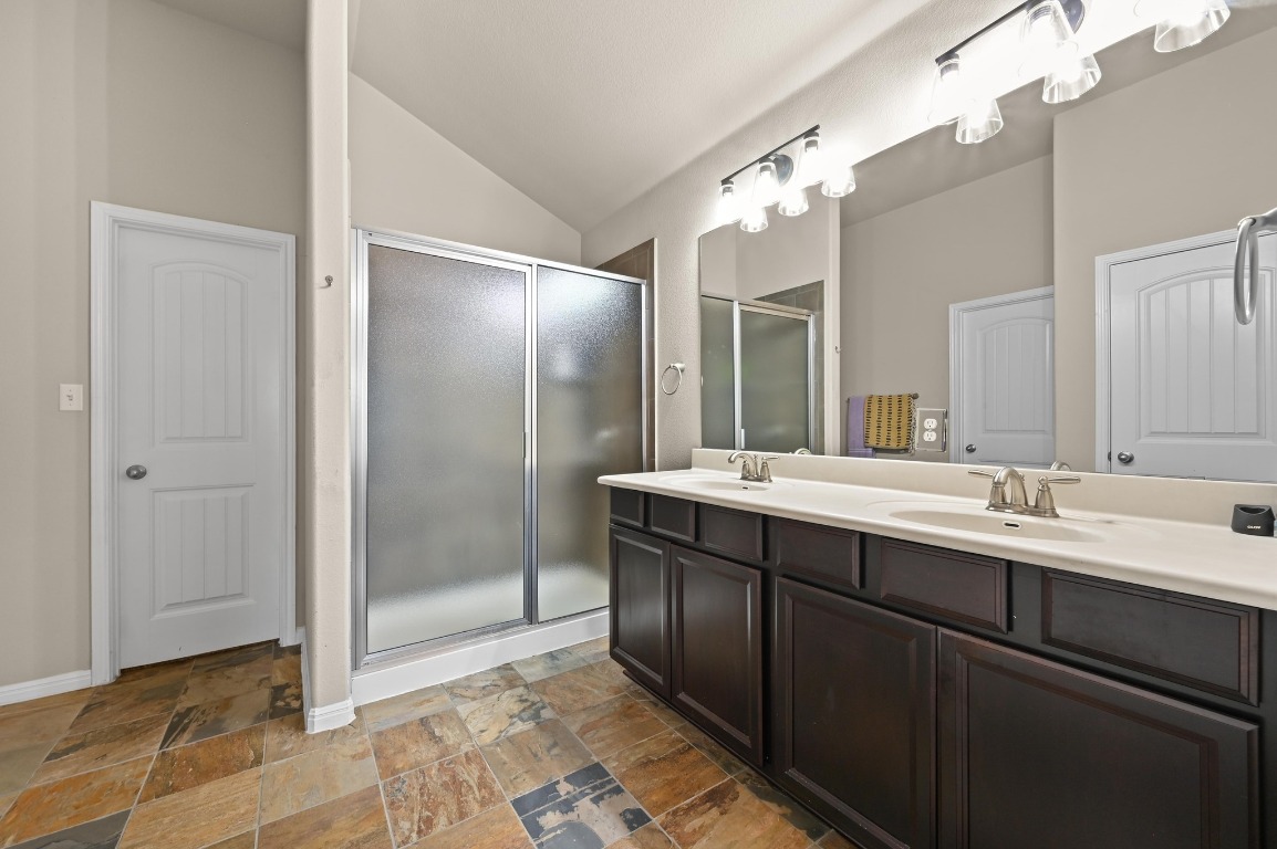 154 Pettigrew Path Buda, TX 78610 - Photo 28 of 36 a bathroom with a double vanity sink and a mirror