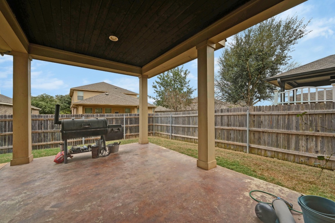 154 Pettigrew Path Buda, TX 78610 - Photo 29 of 36 a view of a deck with wooden floor and fence