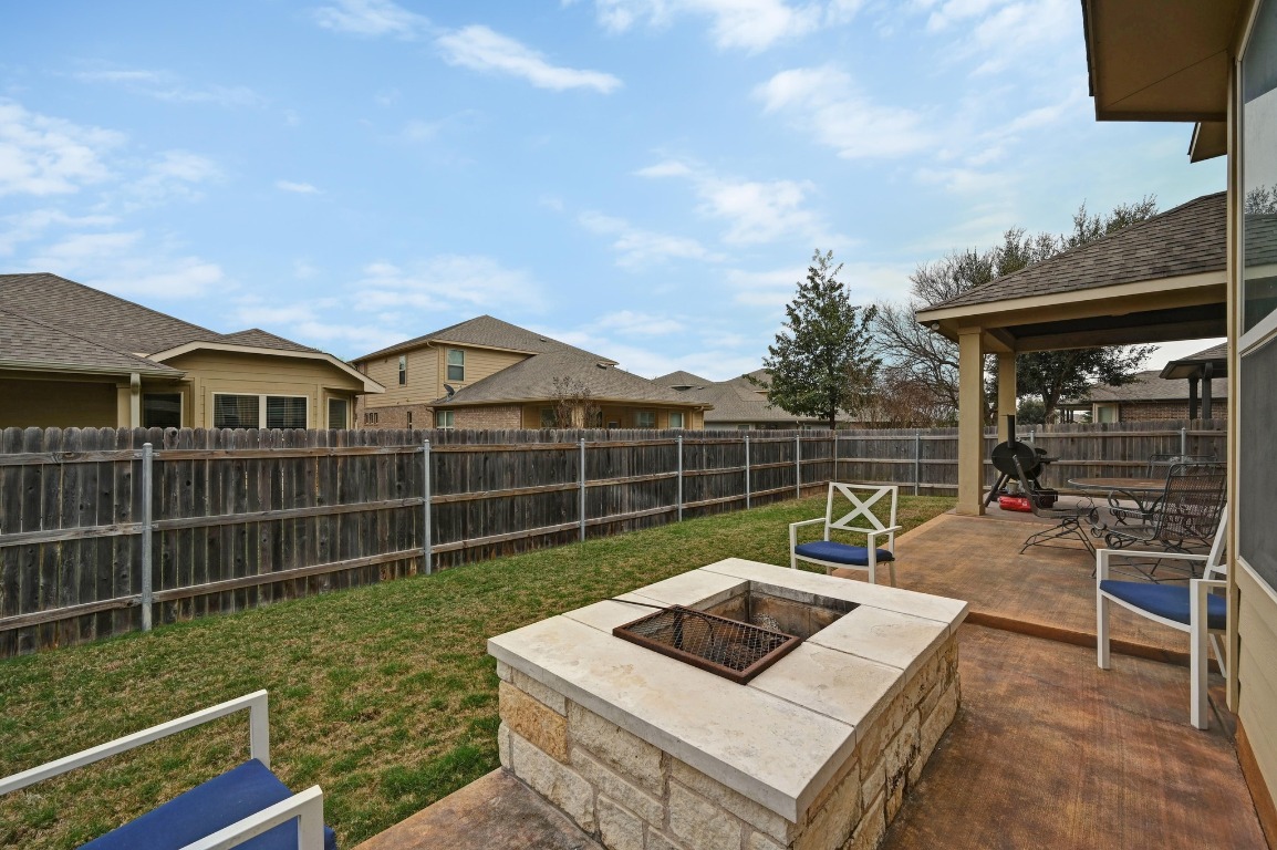 154 Pettigrew Path Buda, TX 78610 - Photo 33 of 36 a view of a backyard with couches chair and wooden floor