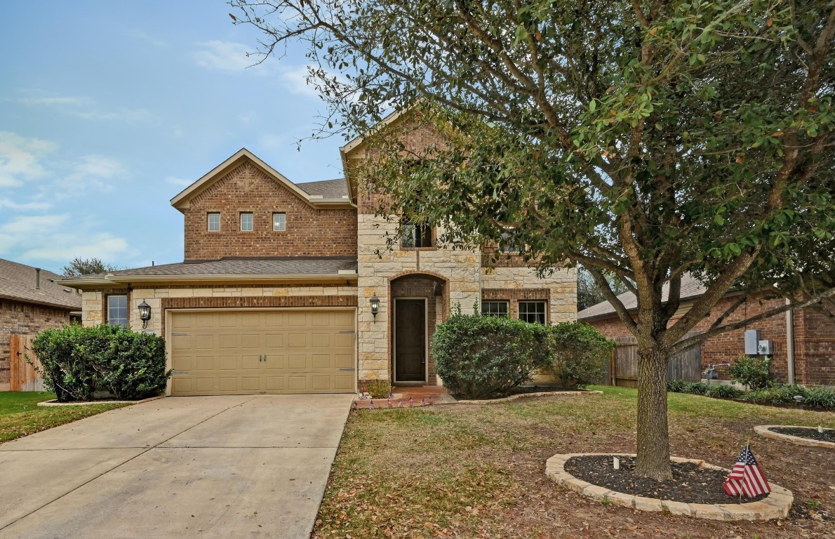 154 Pettigrew Path Buda, TX 78610 - Photo 34 of 36 a front view of a house with a garden