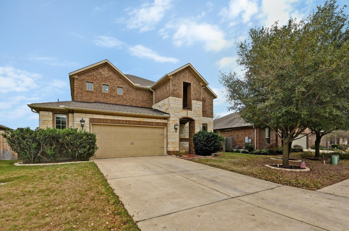 154 Pettigrew Path Buda, TX 78610 - Photo 35 of 36 a front view of a house with a yard