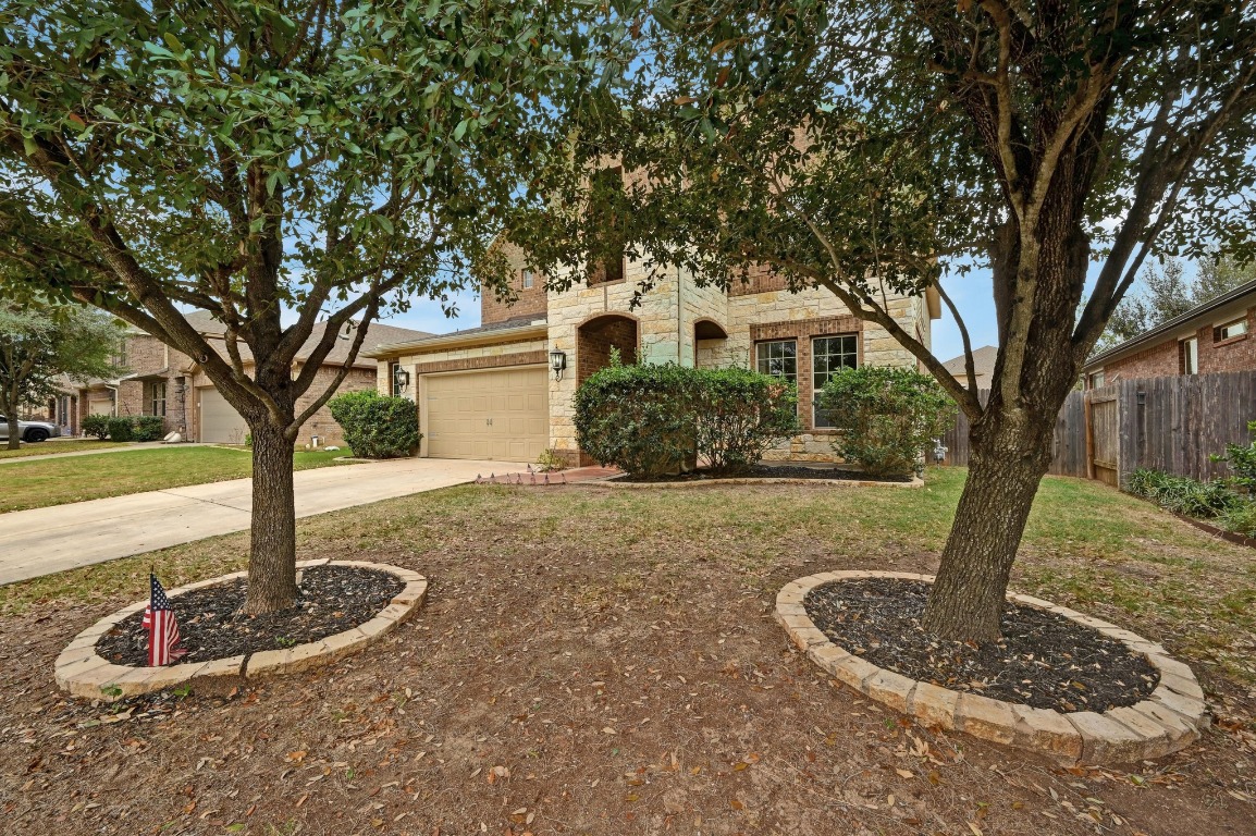 154 Pettigrew Path Buda, TX 78610 - Photo 36 of 36 a front view of a house with garden