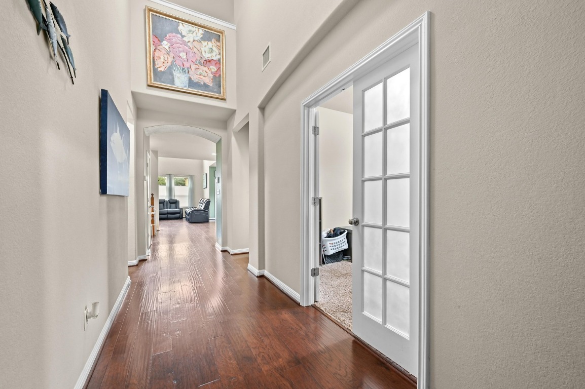 154 Pettigrew Path Buda, TX 78610 - Photo 5 of 36 a view of a hallway with wooden floor and cabinet