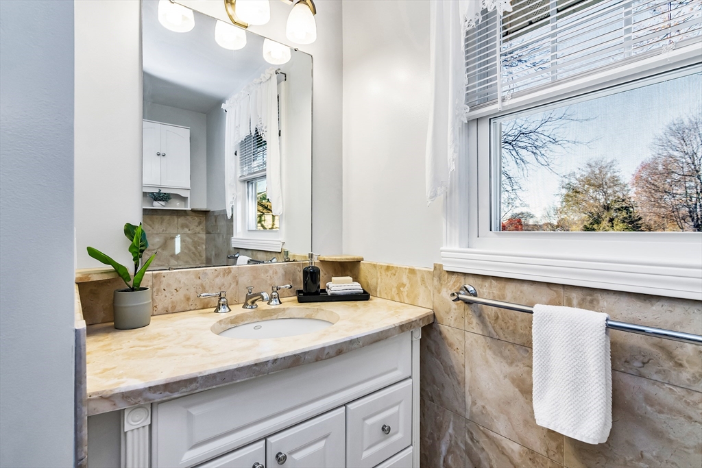 36 Summit Street Salem, MA 01970 - Photo 12 of 42 a bathroom with a granite countertop sink and a mirror