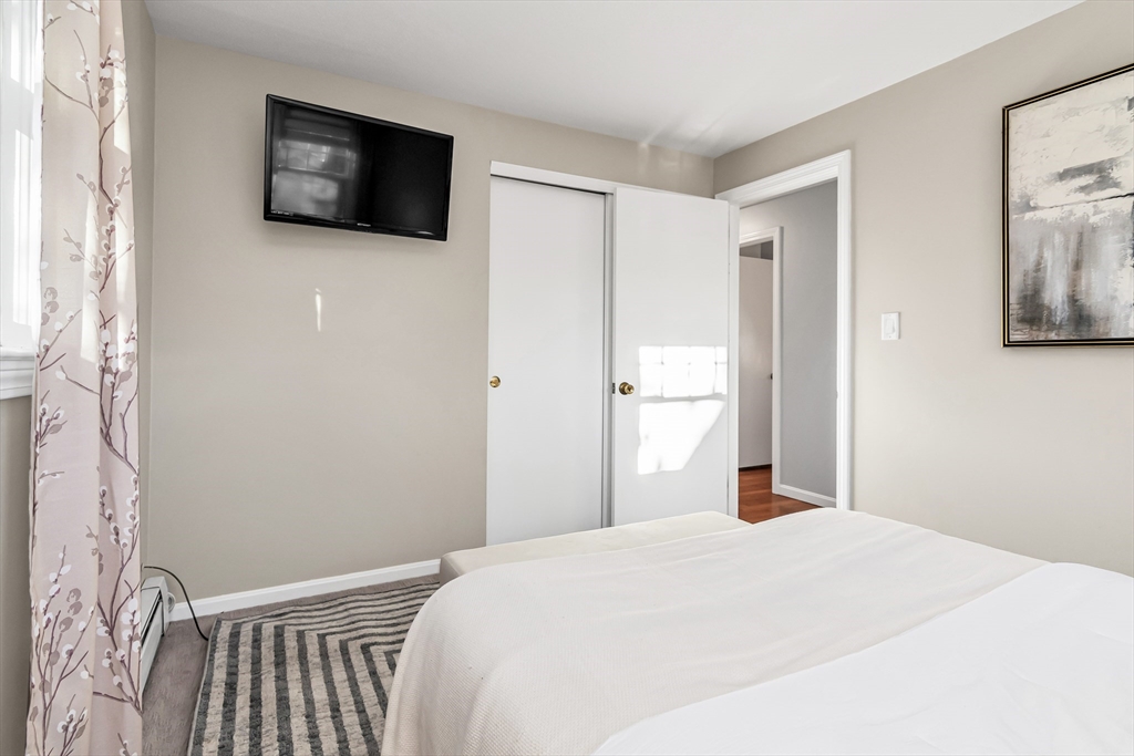 36 Summit Street Salem, MA 01970 - Photo 17 of 42 a bedroom with a bed and a flat screen tv