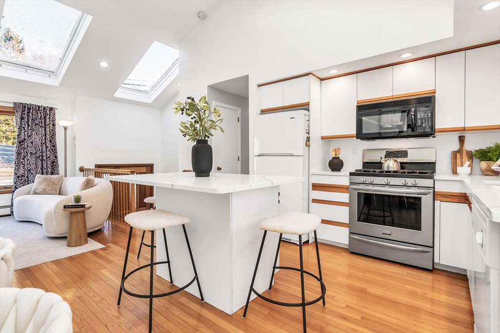 36 Summit Street Salem, MA 01970 - Photo 5 of 42 a kitchen with stainless steel appliances a stove a sink and a microwave