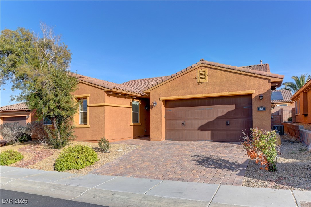 972 Rue Grand Paradis Lane Henderson, NV 89011 - Photo 2 of 32 Mediterranean / spanish-style house featuring stucco siding, decorative driveway, and an attached garage