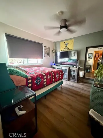 a bed room with furniture and a flat screen tv