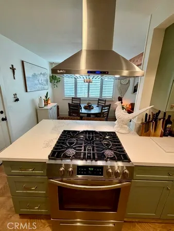 a kitchen with stainless steel appliances granite countertop a stove and a sink