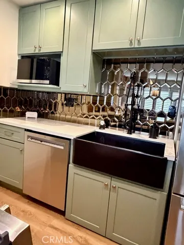 a kitchen with stainless steel appliances granite countertop a sink and a stove