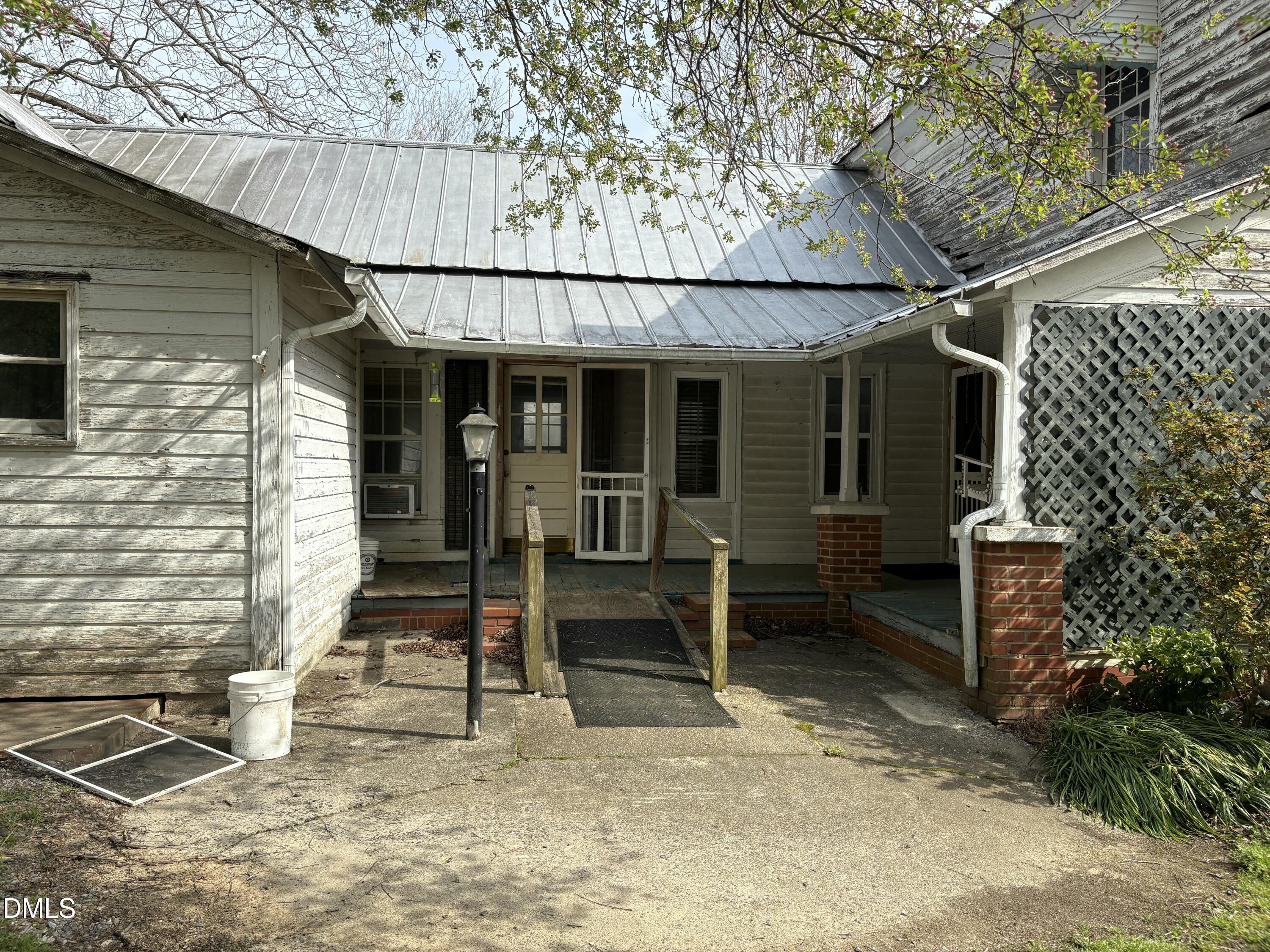 1204 Winfred Brady Road Bennett, NC 27208 - Photo 2 of 16 a front view of a house with a porch