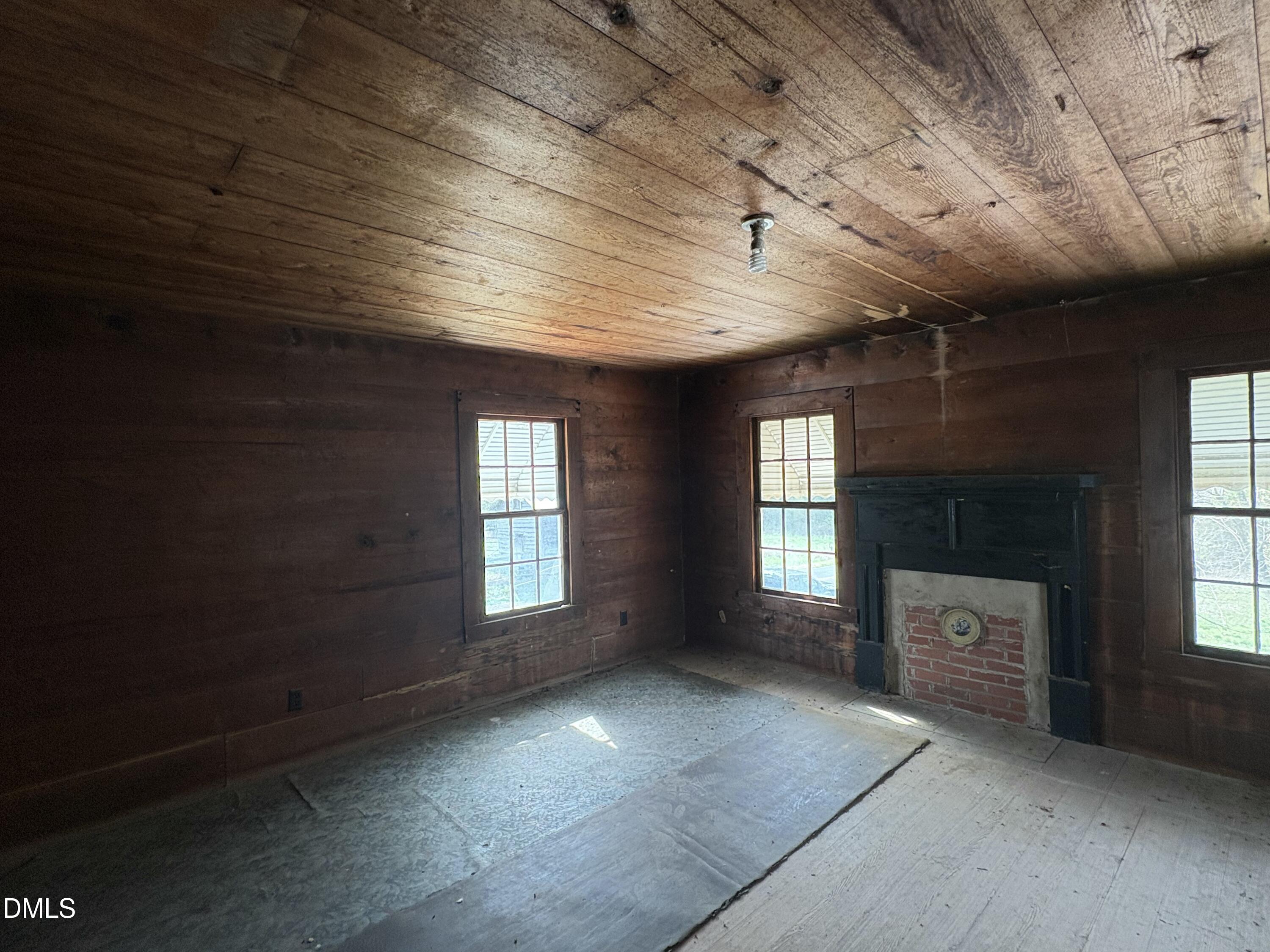 1204 Winfred Brady Road Bennett, NC 27208 - Photo 3 of 16 an empty room with windows