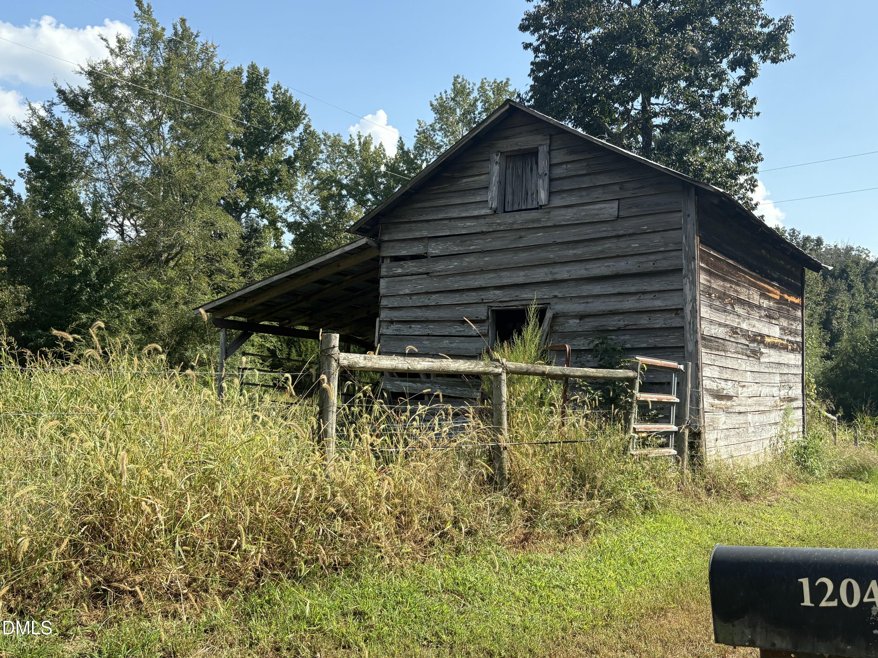 1204 Winfred Brady Road Bennett, NC 27208 - Photo 4 of 5 a backyard of a house with lots of green space
