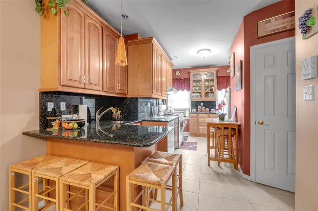 a kitchen with stainless steel appliances granite countertop a refrigerator and a stove top oven