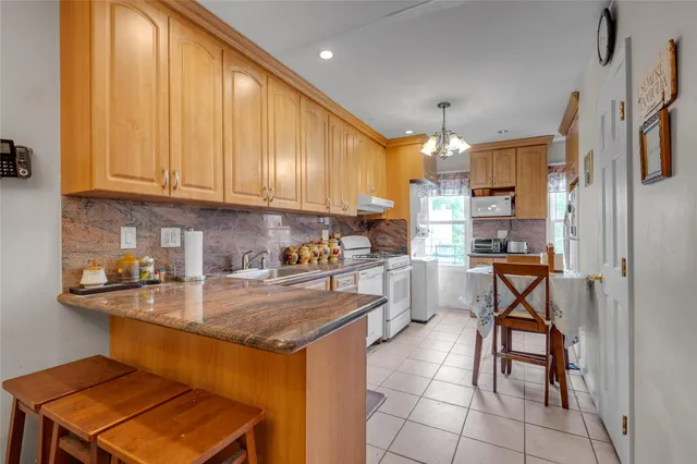 a kitchen with a sink cabinets and window