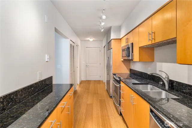 a spacious bathroom with a granite countertop sink and a bathtub