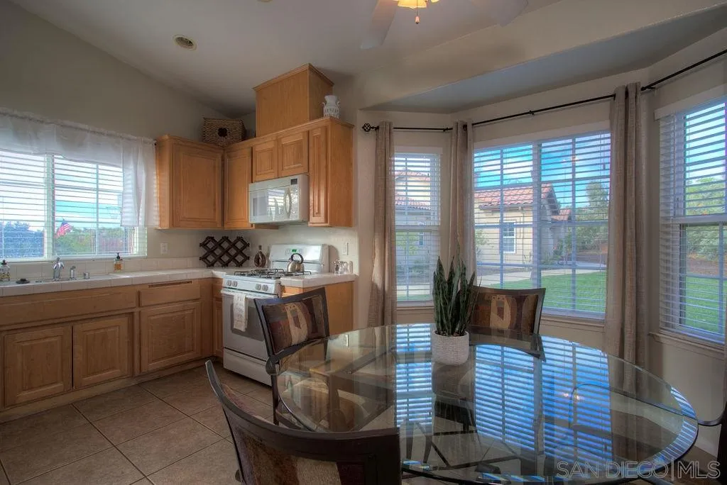 31028 Saddleback Road Valley Center, CA 92082 - Photo 14 of 21 a kitchen with a sink cabinets and dining table