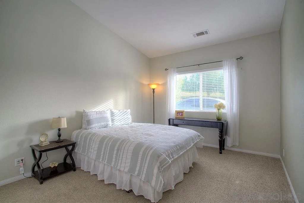 31028 Saddleback Road Valley Center, CA 92082 - Photo 15 of 21 a bedroom with a bed and window