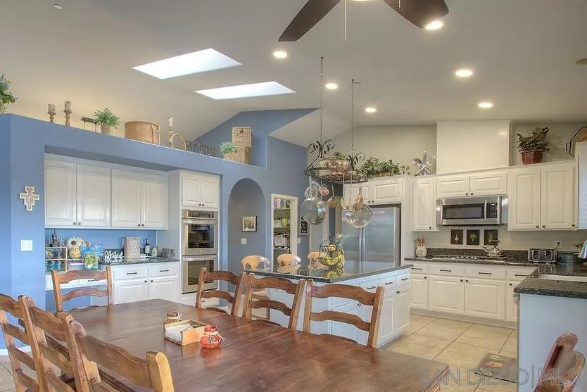 31028 Saddleback Road Valley Center, CA 92082 - Photo 2 of 21 a living room with stainless steel appliances kitchen island granite countertop a sink and cabinets