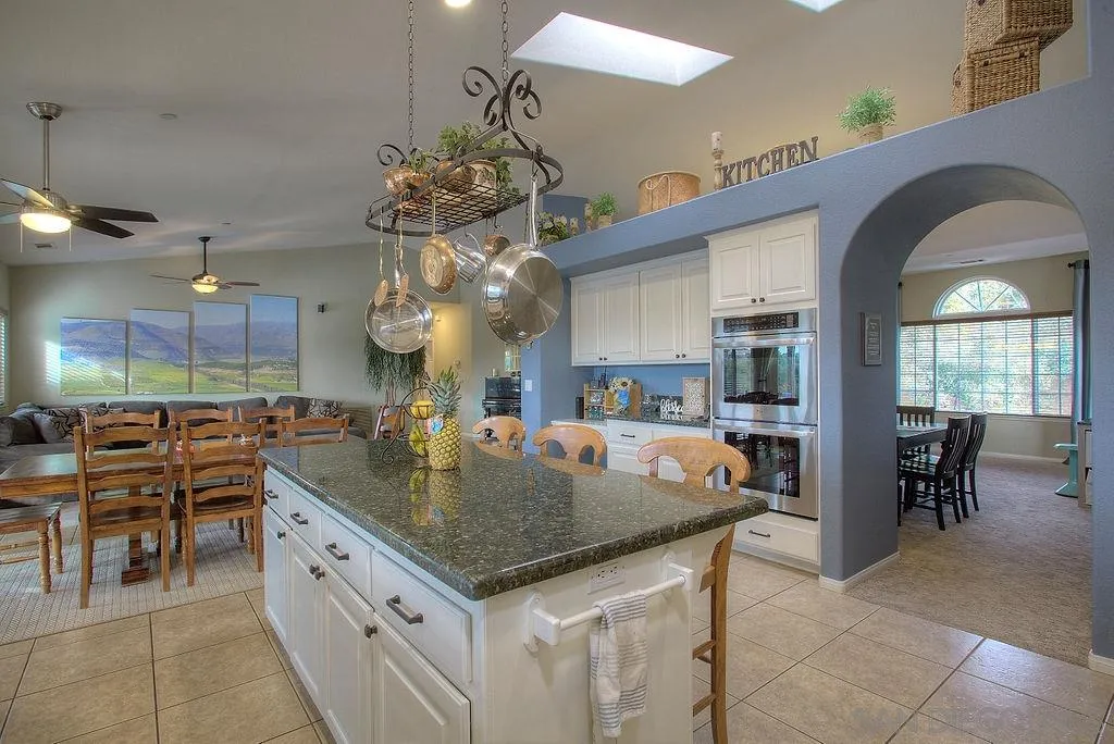 31028 Saddleback Road Valley Center, CA 92082 - Photo 4 of 21 a kitchen with stainless steel appliances granite countertop a sink a stove and a dining table