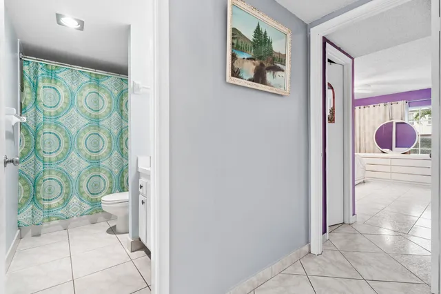 a view of a hallway with bathroom area