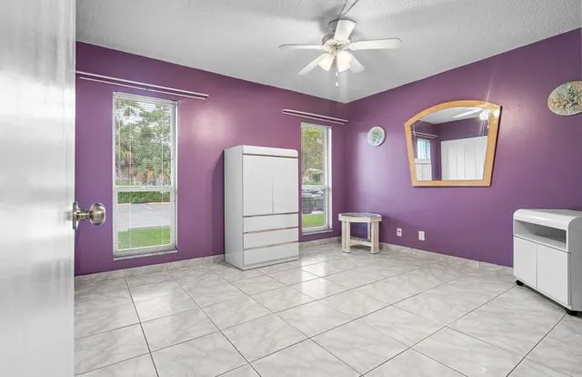 a view of a room with window chandelier fan and fire place