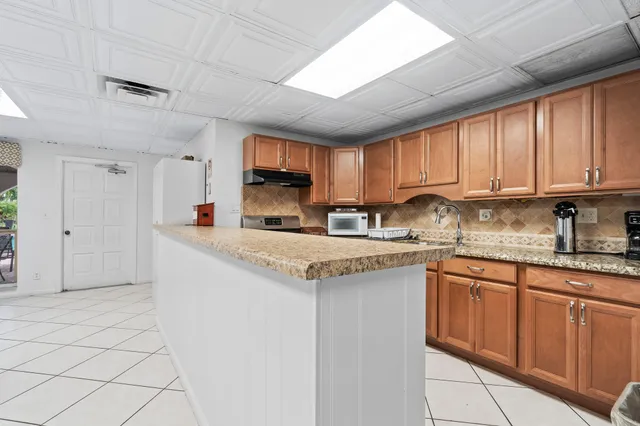 a kitchen with granite countertop a sink and a stove top oven