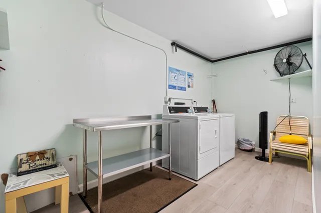 a utility room with multiple dryer and washer