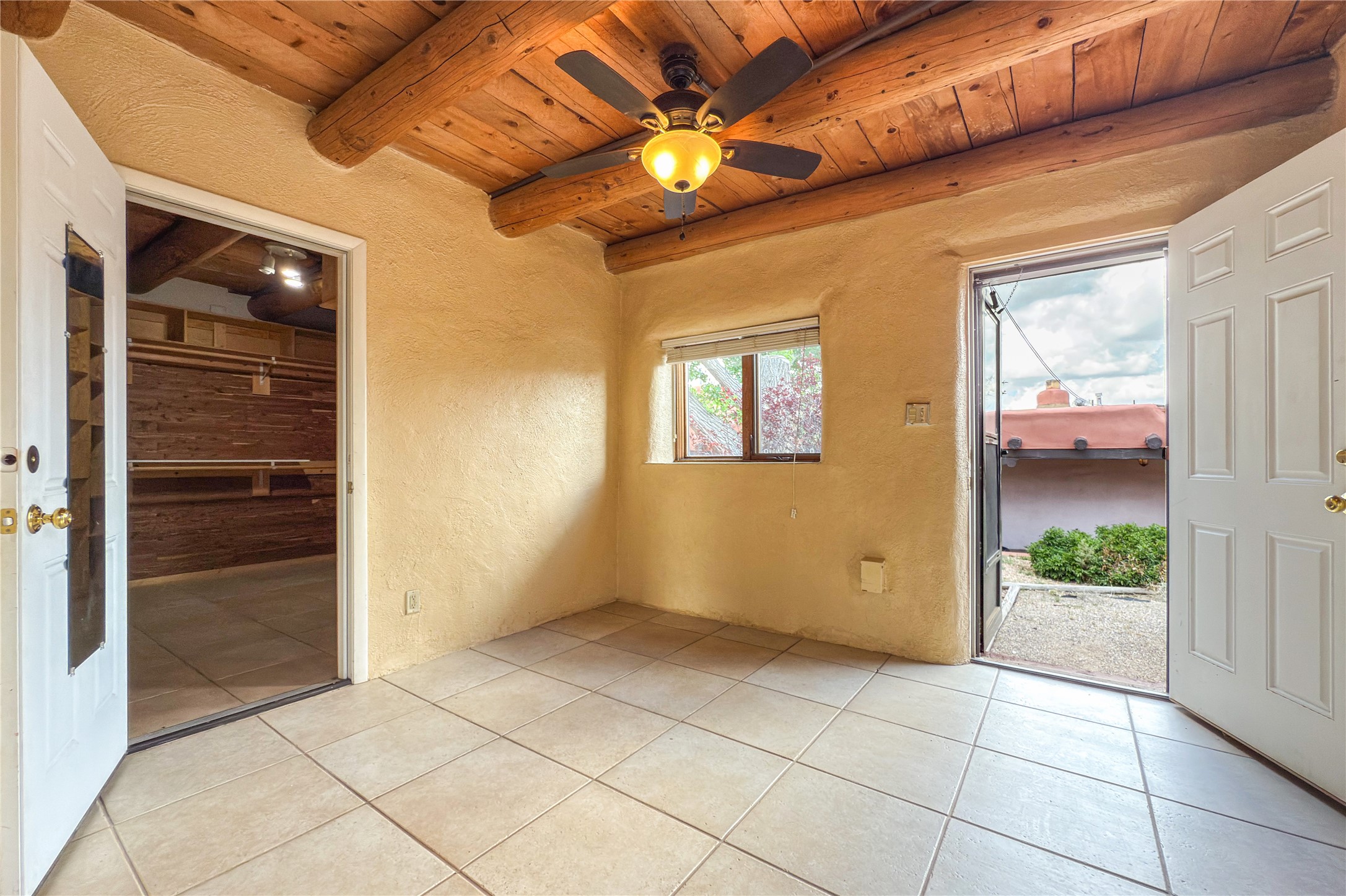 54 Rons Road Santa Fe, NM 87508 - Photo 85 of 99 CASITA: Bedroom with huge cedar closet and access to pool area.