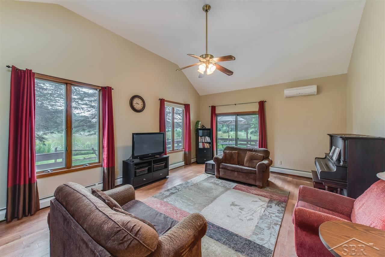 3201 Pomranky Road Midland, MI 48640 - Photo 3 of 29 The large living room has vaulted ceilings and a captivating view out the large windows.