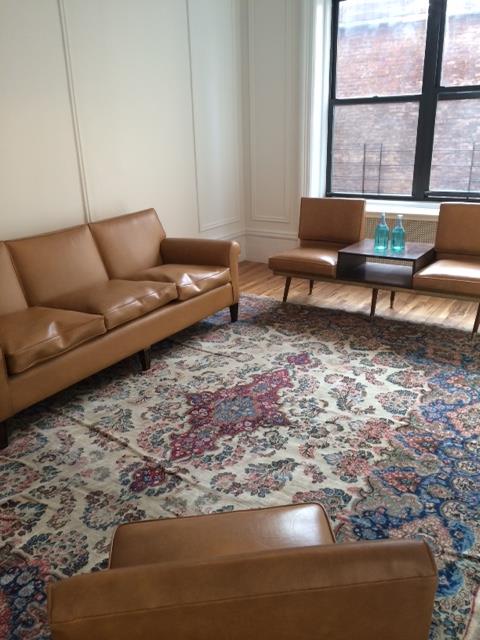a living room with furniture and a rug