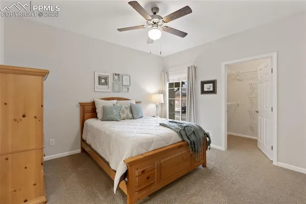 a bedroom with a bed and a ceiling fan