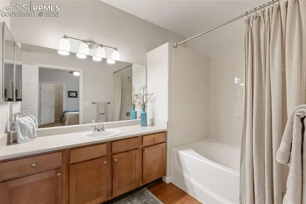 a bathroom with a double vanity sink mirror double and shower