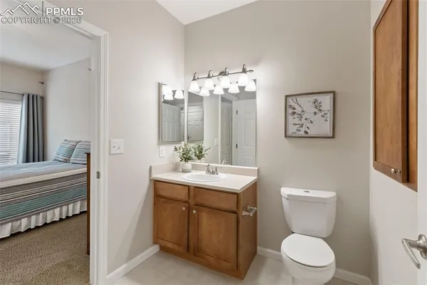 a bathroom with a toilet a sink and mirror